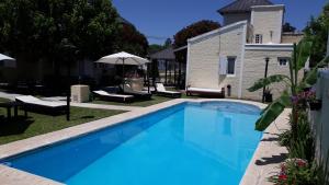 une grande piscine bleue à côté d'un bâtiment dans l'établissement Altos de Unzué, à Gualeguaychú