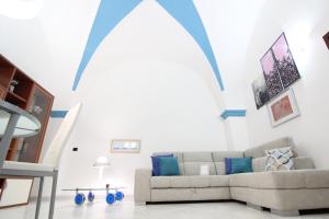 a living room with a couch and a large window at Il Balcone di Giulietta in Locorotondo