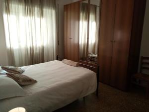 a bedroom with a large white bed and a mirror at L'Angolo Di San Pietro in Rome