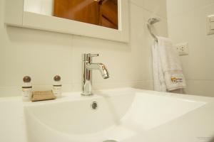 a white sink in a bathroom with a mirror at Hotel San Pedro Plaza in Cusco +68 photos