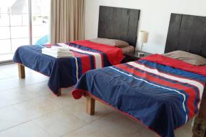Llit o llits en una habitació de Designer´s House Beach Front Superb Ocean View Hi Speed WiFi