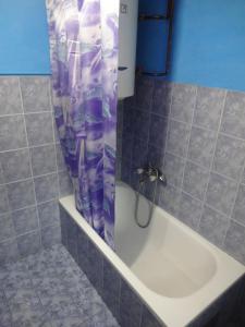 a shower curtain in a bathroom with a tub at Apartman MILENA in Foča