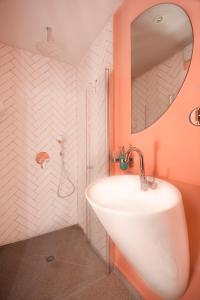 a bathroom with a white sink and a mirror at Glamorous Pink Pearl Studio/Beach/Parking/Netflix in Tel Aviv