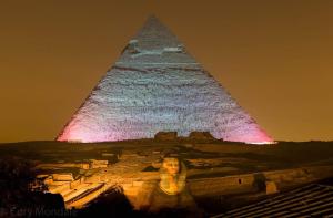 a woman standing next to a statue of a man on a bench at Pyramids View Inn in Cairo