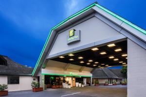 a building with a gas station at Holiday Inn Auckland Airport by IHG in Auckland