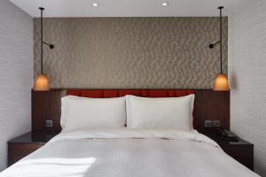 Rúm í herbergi á Tango Inn Taipei ZhongShan