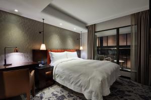 Rúm í herbergi á Tango Inn Taipei ZhongShan