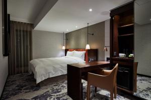 Rúm í herbergi á Tango Inn Taipei ZhongShan