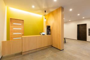 a lobby with a cash register and a yellow wall at M's Hotel Gojo Odawara in Kyoto