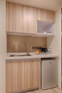 a kitchen with a sink and a refrigerator at Howard Plaza Hotel Hsinchu in Hsinchu City