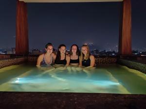 a group of four women laying in a hot tub at night at Arushi Boutique Hotel in Kathmandu