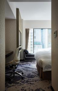 Rúm í herbergi á Tango Inn Taipei ZhongShan