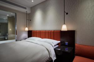 Rúm í herbergi á Tango Inn Taipei ZhongShan
