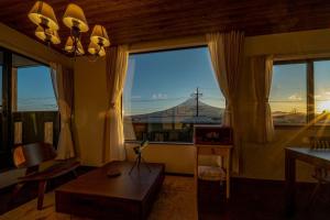 a living room with a large window with a view at Villa Fuji Bon Voyage Mori in Fujikawaguchiko