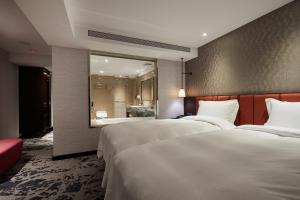 Rúm í herbergi á Tango Inn Taipei ZhongShan