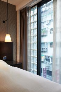 Rúm í herbergi á Tango Inn Taipei ZhongShan