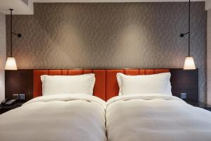 Rúm í herbergi á Tango Inn Taipei ZhongShan