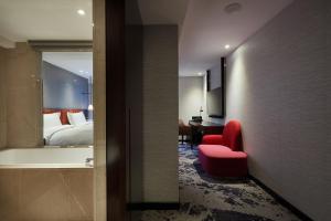 Rúm í herbergi á Tango Inn Taipei ZhongShan