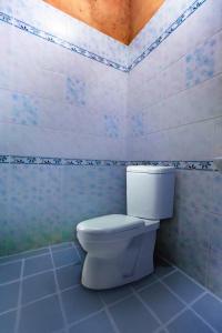 a bathroom with a white toilet in a room at OYO 490 Chiangsan Golden Land Resort2 in Chiang Saen