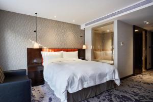 Rúm í herbergi á Tango Inn Taipei ZhongShan