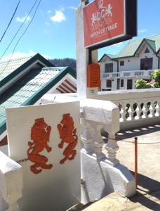 a sign with two bears on the side of a building at Dutch Cottage in Nuwara Eliya