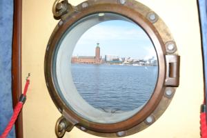 a mirror on a boat with a view of the water at Den Röda Båten in Stockholm