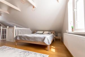 a bedroom with a bed in a white room at Silbernagel Apartment in Kuressaare