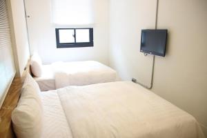 Postel nebo postele na pokoji v ubytování Home Rest Hotel 2