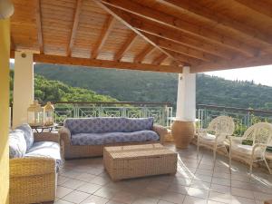 a porch with wicker furniture and a view of a mountain at Villa Eos in Gaios