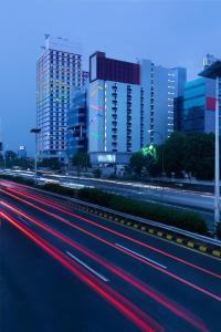 a city with buildings and cars on a highway at Amaris Hotel Slipi in Jakarta