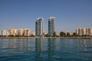 a large body of water with buildings in the background at Olympic Residence Deluxe Apartments in Limassol