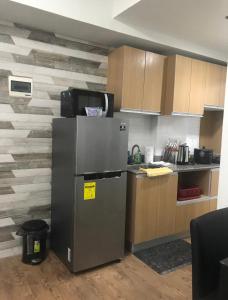 a kitchen with a stainless steel refrigerator and a counter at Seaview Amani Grand Resort Residences 3-5mins from airport in Mactan
