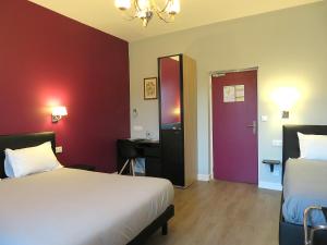 Postel nebo postele na pokoji v ubytování Hôtel Le Dormeux