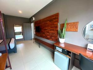 a room with a desk with a potted plant on the wall at Patuxay Place in Vientiane