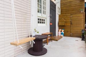 a porch with a bench and a table and a door at 獨立空間麻雀小屋温馨4-6人溜滑梯房 in Wujie