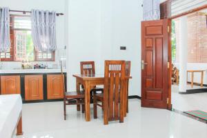 a kitchen with a dining room table and chairs at Temple Tree Mirissa in Mirissa