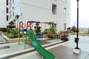 a playground with a green slide in a building at Cozy Studio Apartment at Margonda Residence 4 By Travelio in Depok