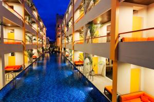 a view of a hotel hallway with a swimming pool at FuramaXclusive Sandara Hua Hin at Cha-am Beach in Cha Am