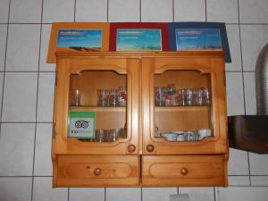 a wooden hutch with certificates on top of it at Host Tina in Bucharest