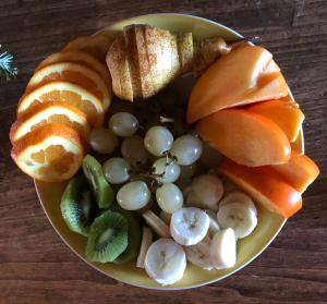 a plate of fruit and vegetables on a table at Cascina La Maddalena Bed & Wine in Rocca Grimalda