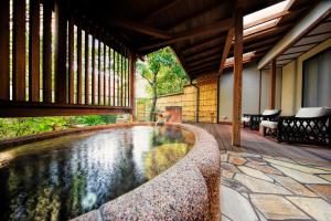 - une piscine d'eau sur une terrasse avec une maison dans l'établissement Yumeguri no Yado Yoshiharu, à Izunokuni