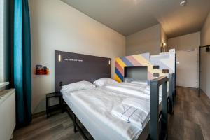 a bedroom with two bunk beds in a room at a&o Graz Hauptbahnhof in Graz