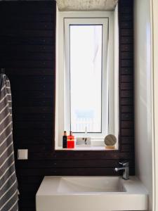 a bathroom with a sink and a window at CASA DO MAR in Jardim do Mar +47 photos