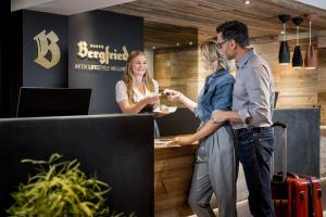 a group of people standing around a reception desk at Ferienvilla Bergfried in Tux +43 photos