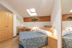 Un pat sau paturi într-o cameră la Albergo Conca Verde