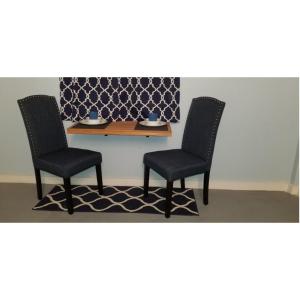 a table with two chairs and a table with a plate on it at Careffe Suites Unit 4 in Cap Estate