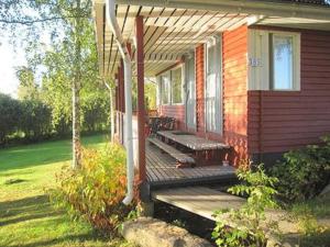 a porch of a house with a bench on it at Holiday Home Viljamaan lomamökit 2 by Interhome in Vaskivesi