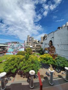 a view of a city with a statue of a woman at Art'otel Ximending Taipei in Taipei