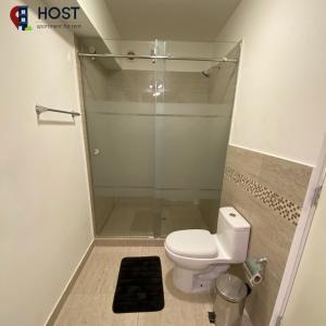 a bathroom with a toilet and a glass shower at Host - San Isidro Sta Catalina in Lima