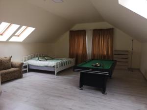 a bedroom with a bed and a pool table at Apartamentai Rimkuose in Klaipėda